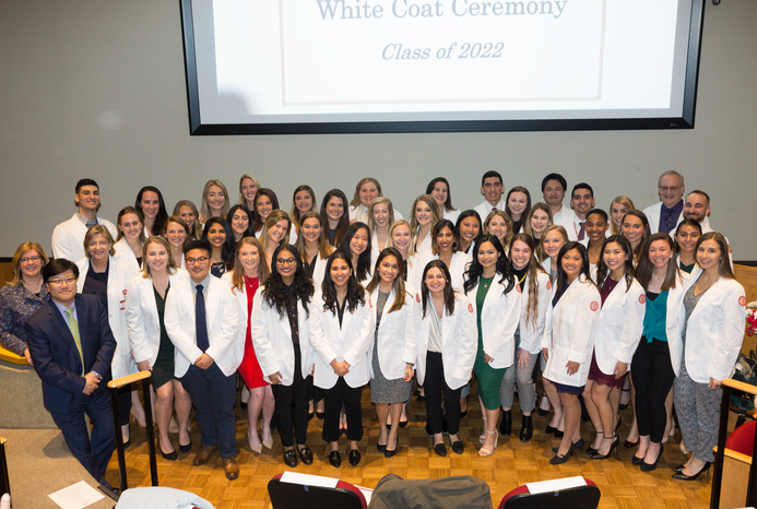 Students gathered together to take a photo at their white coat ceremony