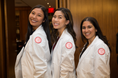 Three girls pose for a picture at the PA white coat ceremony