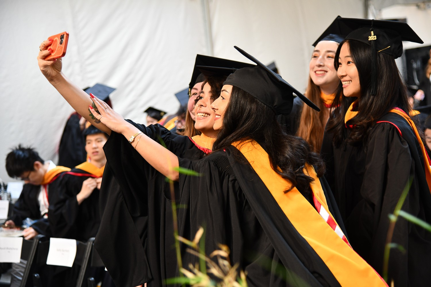 Graduating students in the Class of 2023 pose for a selfie