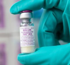 Green-gloved hand holding vial of BCG