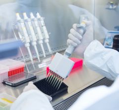 gloved scientist using multipipette