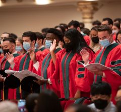 students at graduation reciting the Hippocratic oath.